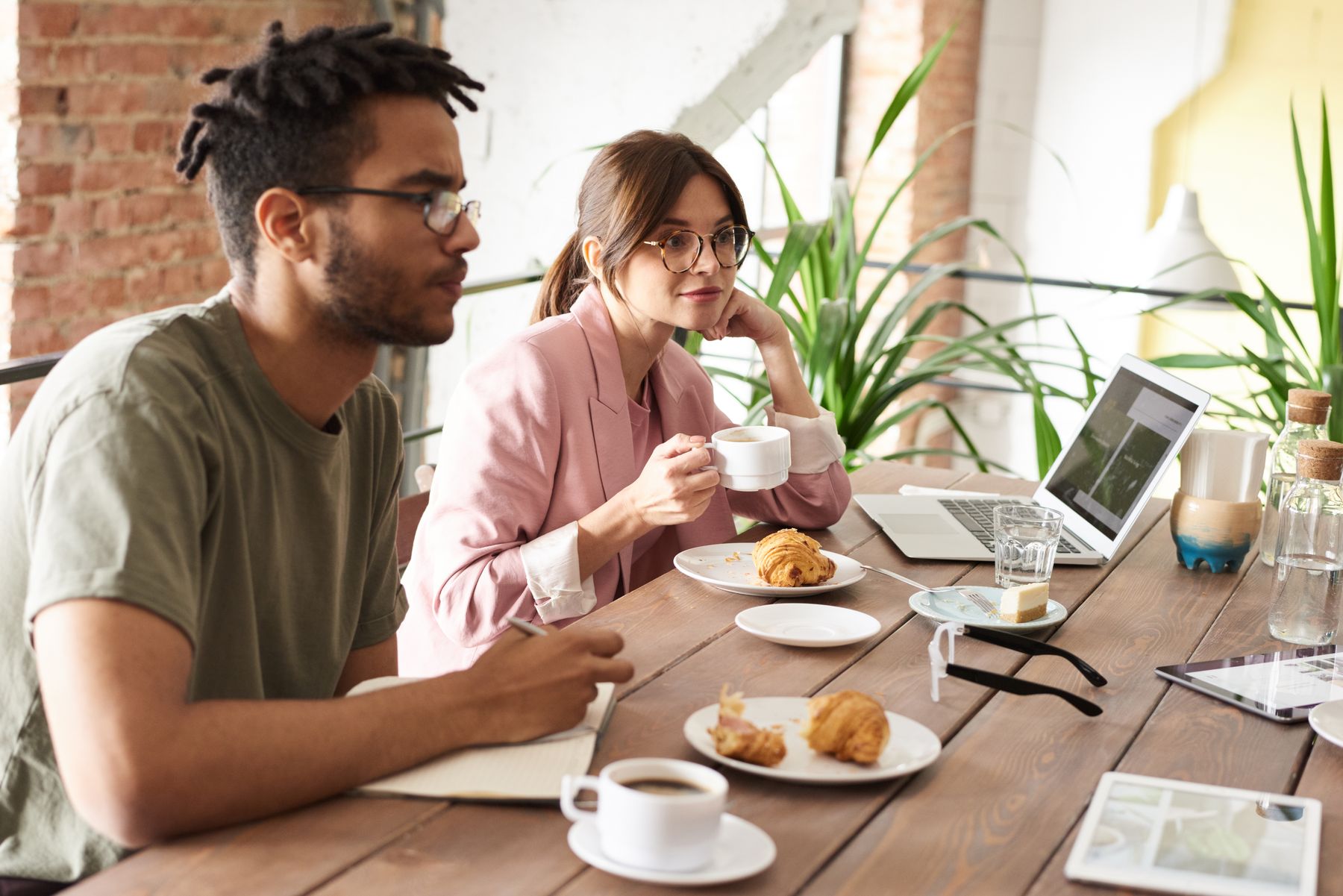 Colegas tomando café e comendo no ambiente de trabalho; imagem ilustrativa